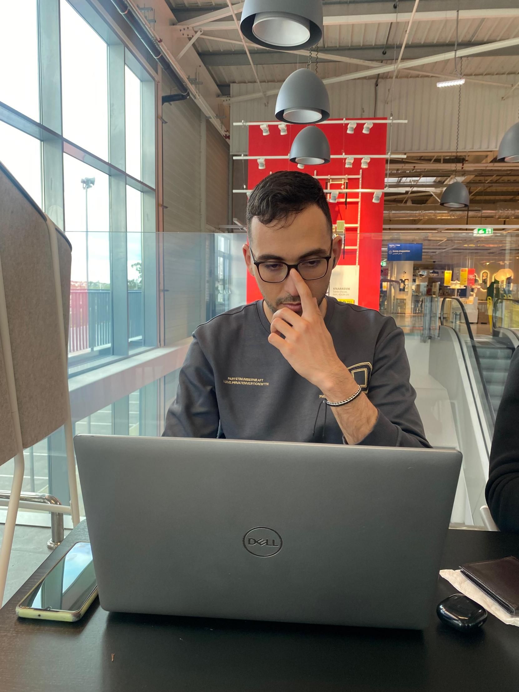 Mohamed Nahli working on a laptop